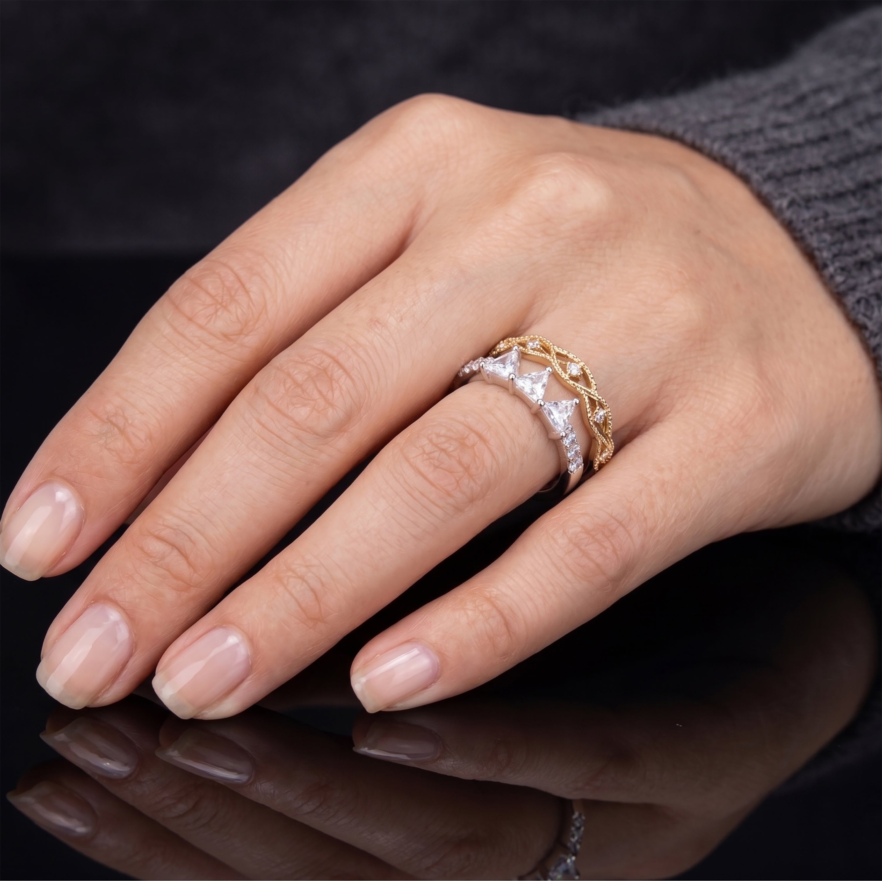 Model wearing the 925 sterling silver crown tiara ring as part of a modern ringscaping stack on a finger.