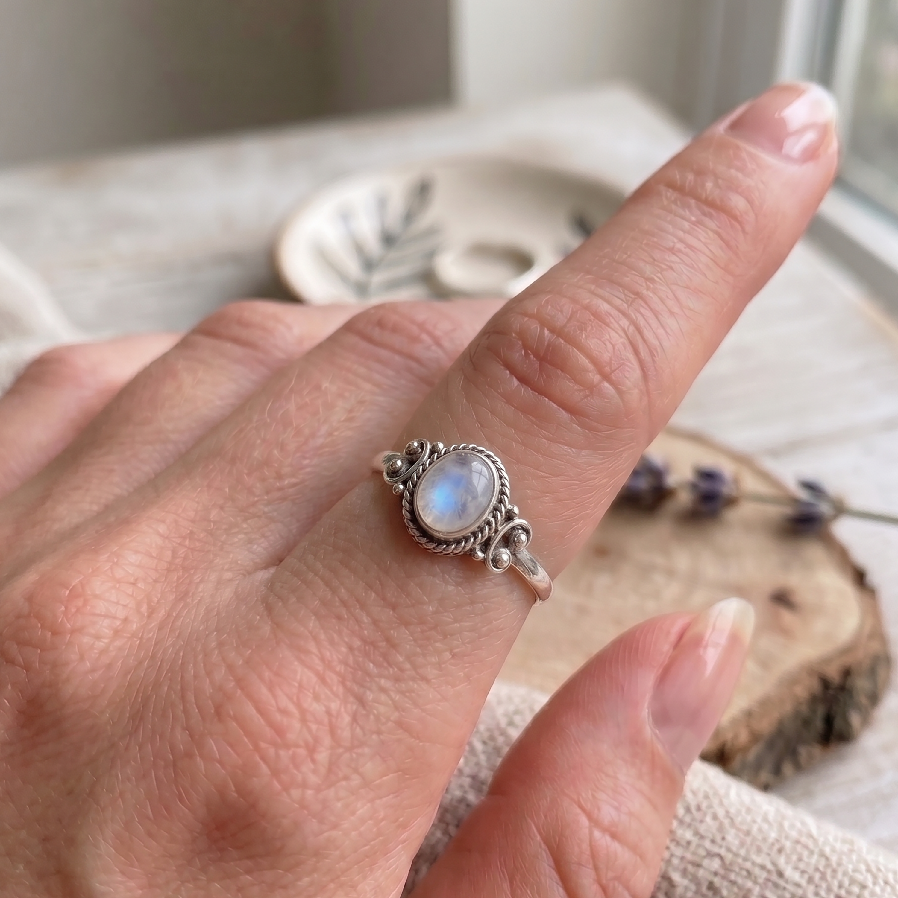 Sterling silver moonstone ring on hand, handcrafted boho jewelry by Faris Jewels, 925 silver gemstone ring for women, dainty minimalist statement ring.